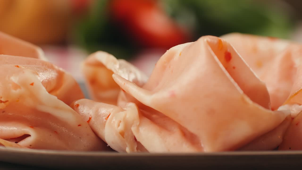 Ham italian mordatella, man Slices Of Traditional Italian antipasti mortadella sausage on a wooden cutting board, close up macro of chicken or turkey jamon, fat breakfast dish.
