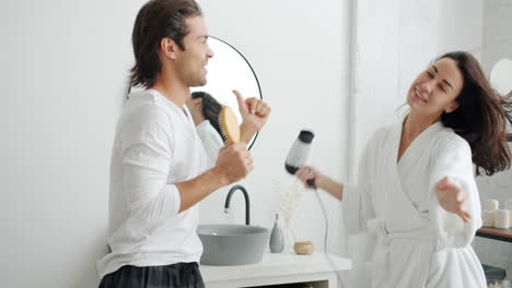 couple singing and dancing in bathroom