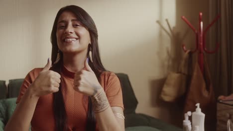 woman smiling and showing thumbs up