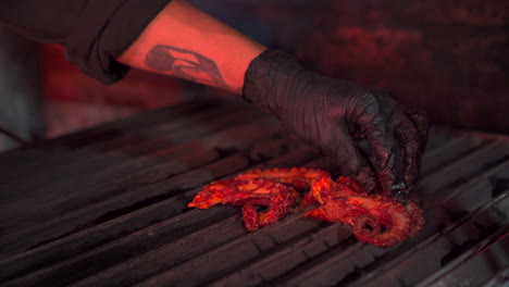 barbecue chef put octopus tentacle to the grill