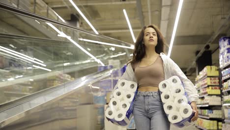 woman shopping for toilet paper in a grocery store