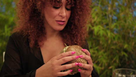 Woman Biting A Burger With Tuna Fish During The Resort Dinner