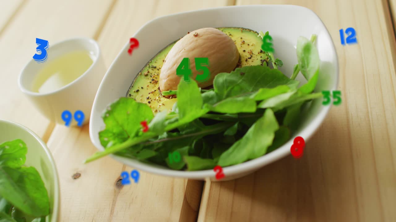 Opening tight view starting camera panning left, revealing avocado bowl, dressing cup, salad bowl