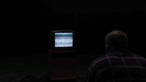 person watching old television with static