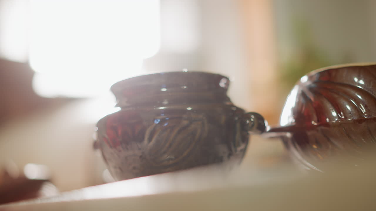 Warm kitchen scene. Calm domestic kitchen captured in soft morning light and warm hues. Serene home kitchen featuring sunlit ceramic container with subtle simmering in peaceful morning ambiance