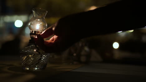 lit antique oil lamp on table in cafe