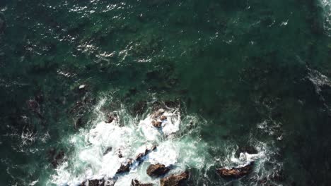 Slow-Motion-Birds-Eye-View-POV-of-the-ocean-in-Asilomar-Beach-in-Monterey