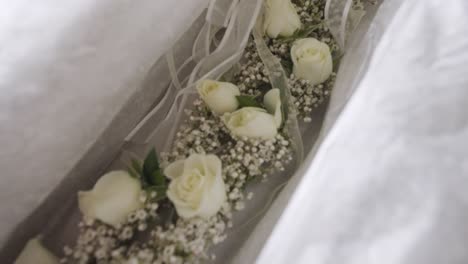 a box of white rose flower crowns for a greek wedding