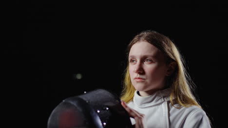 young woman fencing in a competition