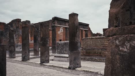 stone columns at pompeii ruins, overcast sky, italy