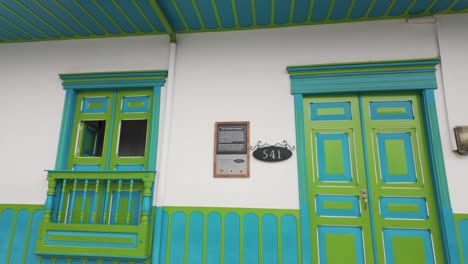 Green-painted-doors-in-small-town-Salento,-Colombia,-famous-travel-spot