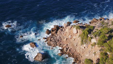 Mar-Azul-Oscuro-Con-Olas-Rompiendo-En-Un-Acantilado-Escarpado-En-Mallorca,-Vista-Panorámica