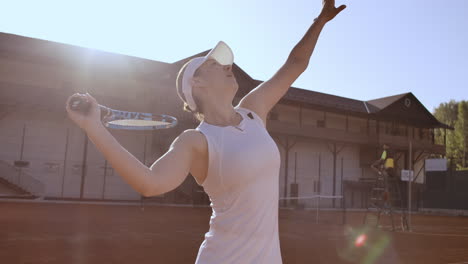 tennis player prepares to serve ball during tennis match