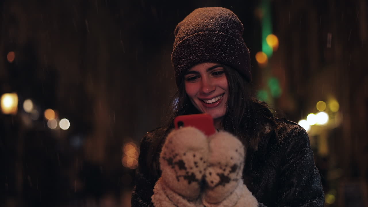Woman using mobile phone in winter