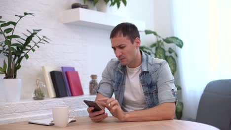 Surprised-and-shocked-man-looking-at-the-smartphone-screen