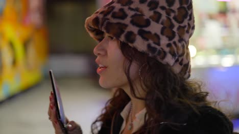 young woman talking on phone at a night market