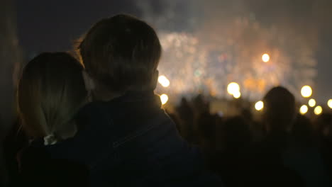 mother and little son watching fireworks