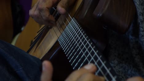 acoustic guitar being played by musician