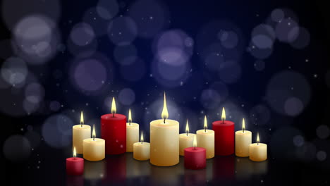 red and yellow candles with flame on table burning on blue background with blurred round highlights. looped animation motion.