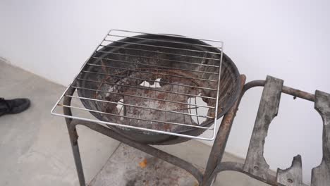 close up of a rusty and hollow but still functional grill on a rooftop in the daytime in 4k