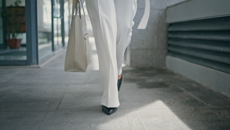 stylish woman legs walking office in high heels closeup. girl feet going on work