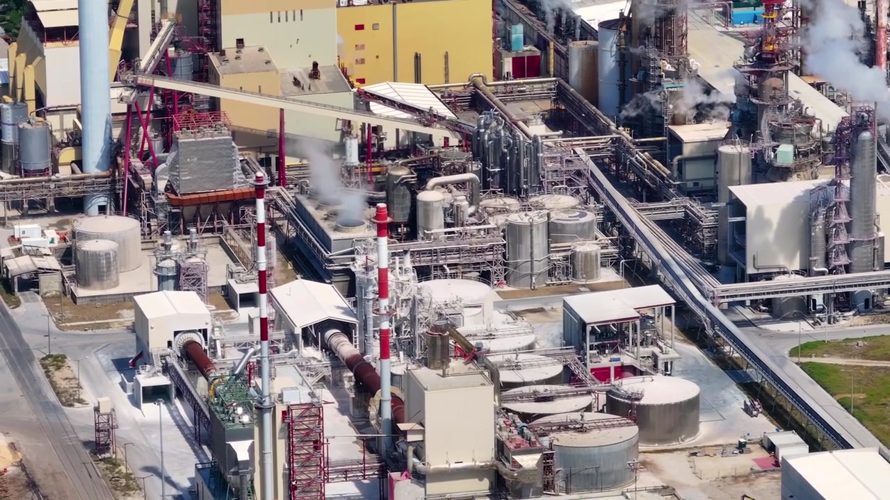 Industrial pulp mill complex with smoking chimneys processing eucalyptus. Aerial view of the facility for cellulose production and bioenergy