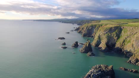 drone flying along dramatic coast with cliffs and rock formations copper coast waterford ireland