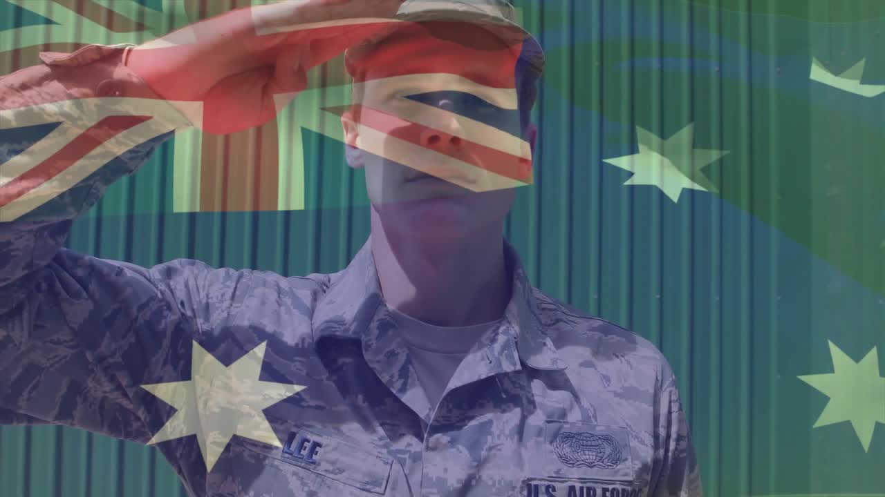 Airman tilting head, raising arm and holding salute honoring Australian flag overlay aligning torso