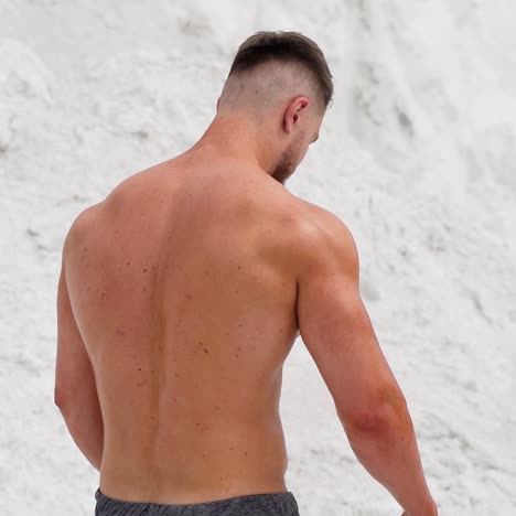 athletic male resting after work out on nature