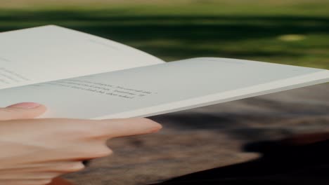 person reading a book outdoors