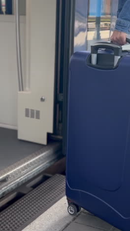 a tourist enters a train car with luggage. train ride