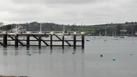 looking up falmouth harbour with derelict jetty in background at low tide