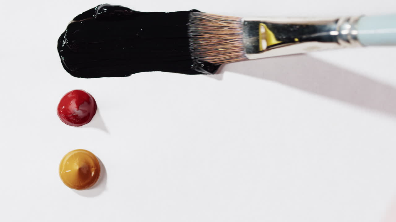 Paint brush and colorful paints