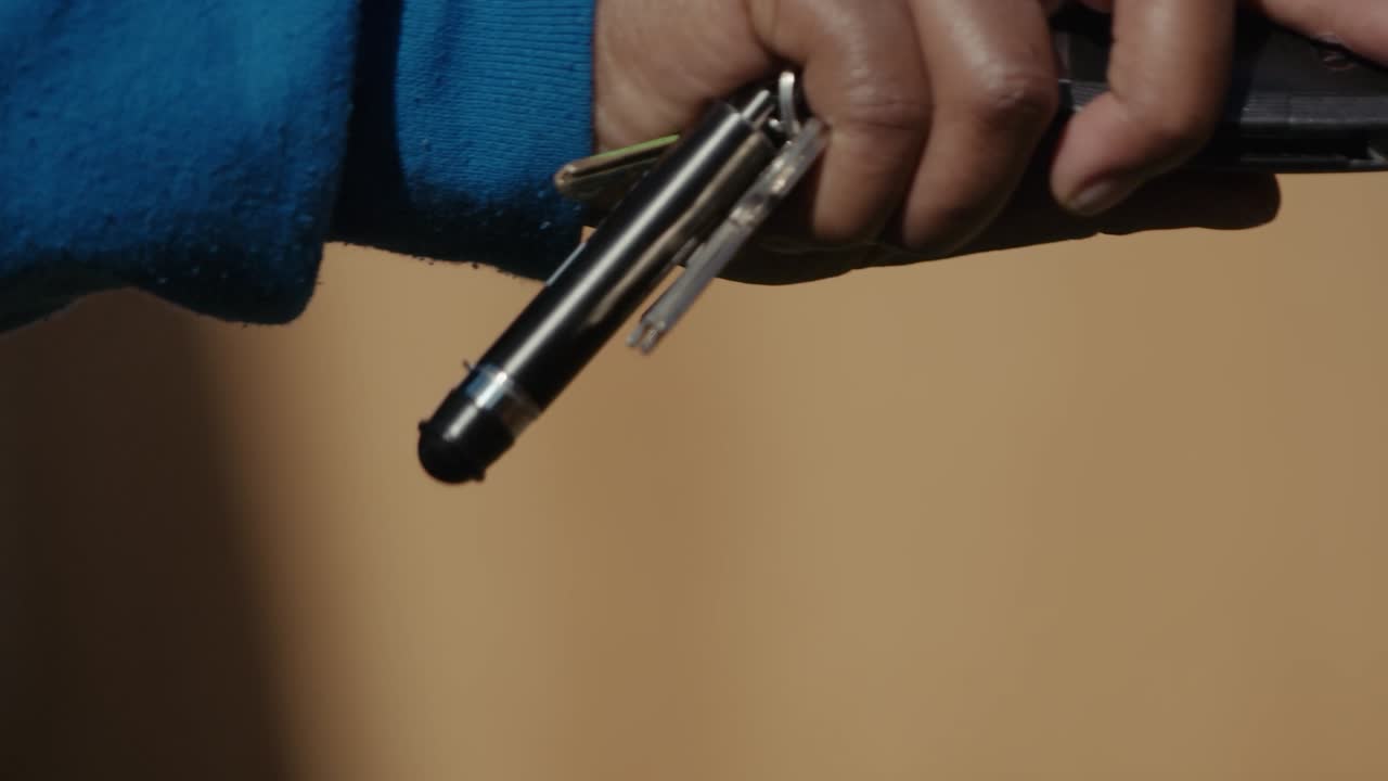 una mano de piel marrón gira una llave antes de insertarla