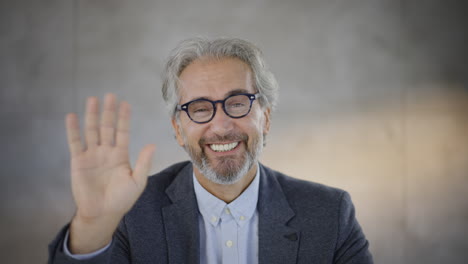 man waving during video conference