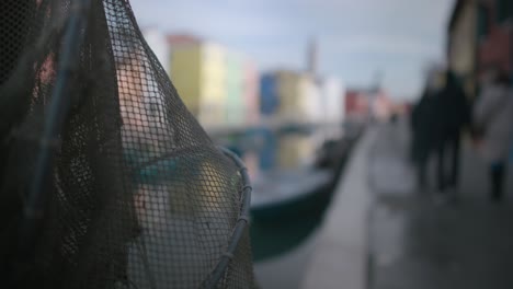 Fishing-net-foreground-with-Burano-canal-behind,-Italy