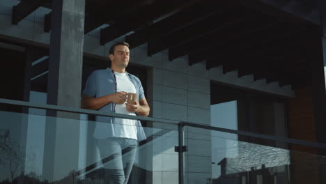 successful man drinking coffee at modern house