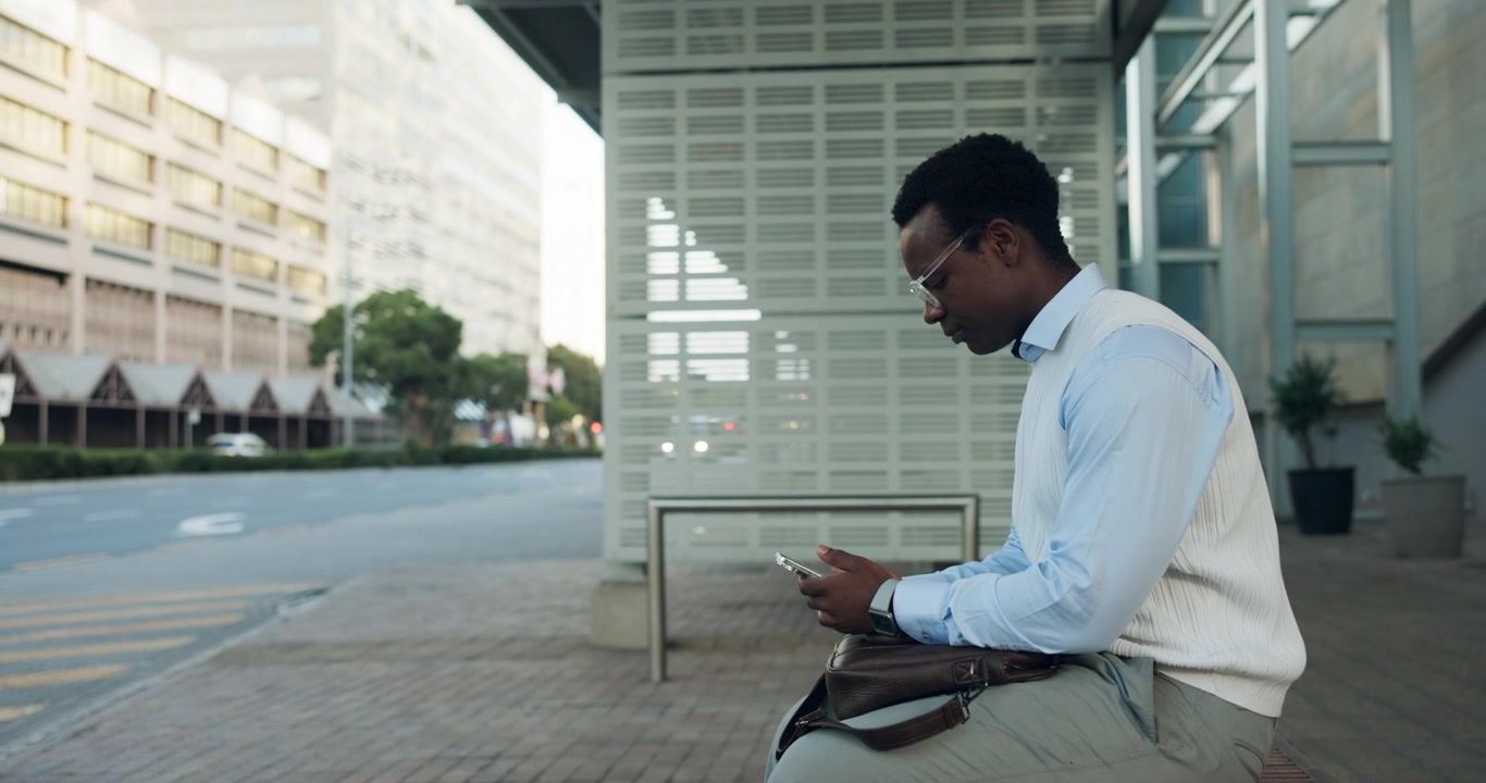 Young Professional Man Using Smartphone at City Bus Stop