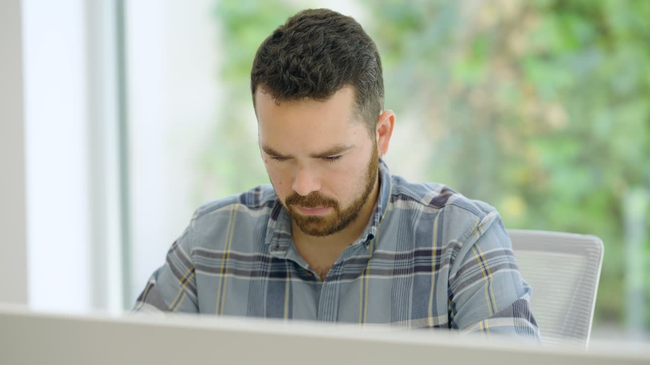 Focused employee working on computer in office