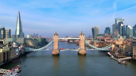 aerial dolly backwards view, thames river transportation, tower bridge