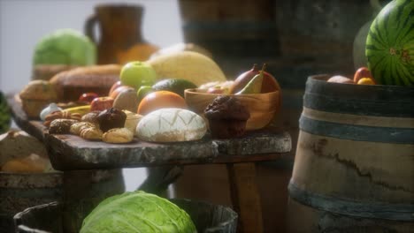 mesa de comida con barriles de vino y algunas frutas, verduras y pan