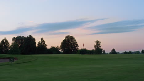 beautiful sunset golf course park. sun setting on dawn park landscape in evening