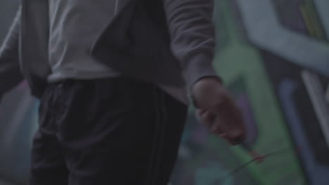 close up shot of young athletic man's hands whilst he's jumping rope - skipping in an underpass, in slow motion - ungraded