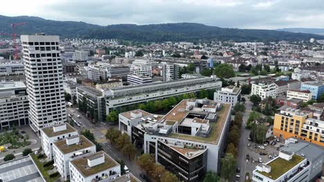 drone flight over modern city of zurich with solar panels on roof of apartment blocks