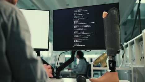 programmer working on code with a prosthetic leg