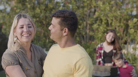 Portrait-of-happy-husband-kissing-his-wife-outdoors