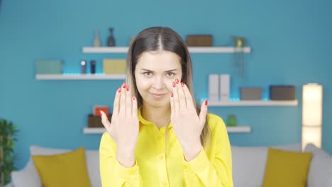 beautiful young woman showing her nail polish fingers.