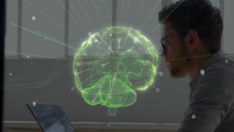 male researcher leaning toward laptop in tech lab, interacting with glowing green holographic brain
