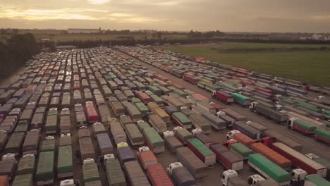 aerial view of a bunch of cargo trucks with the sun behind