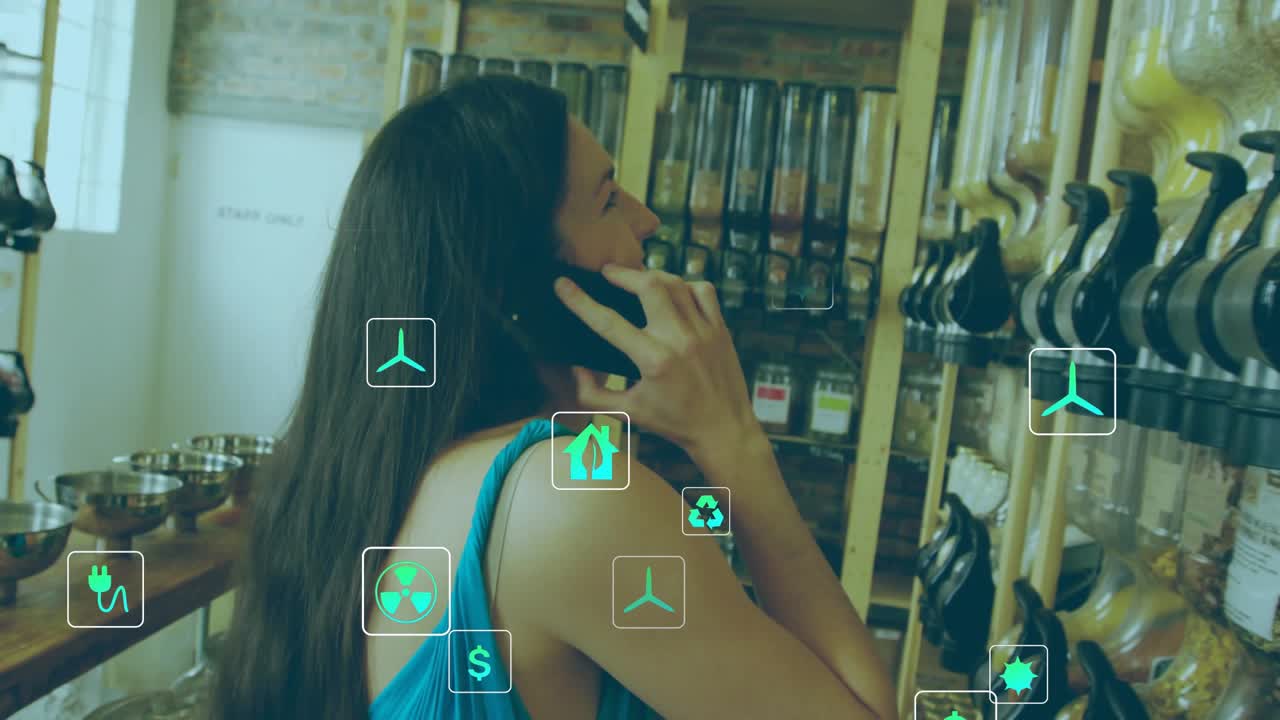 Woman walking bulk aisle, talking on phone and browsing bins, causing green icons showing eco price